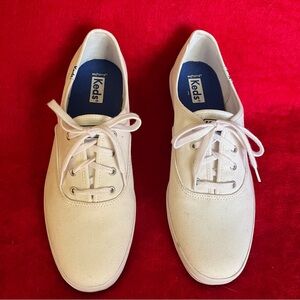 Keds women’s white lace-up sneakers.
